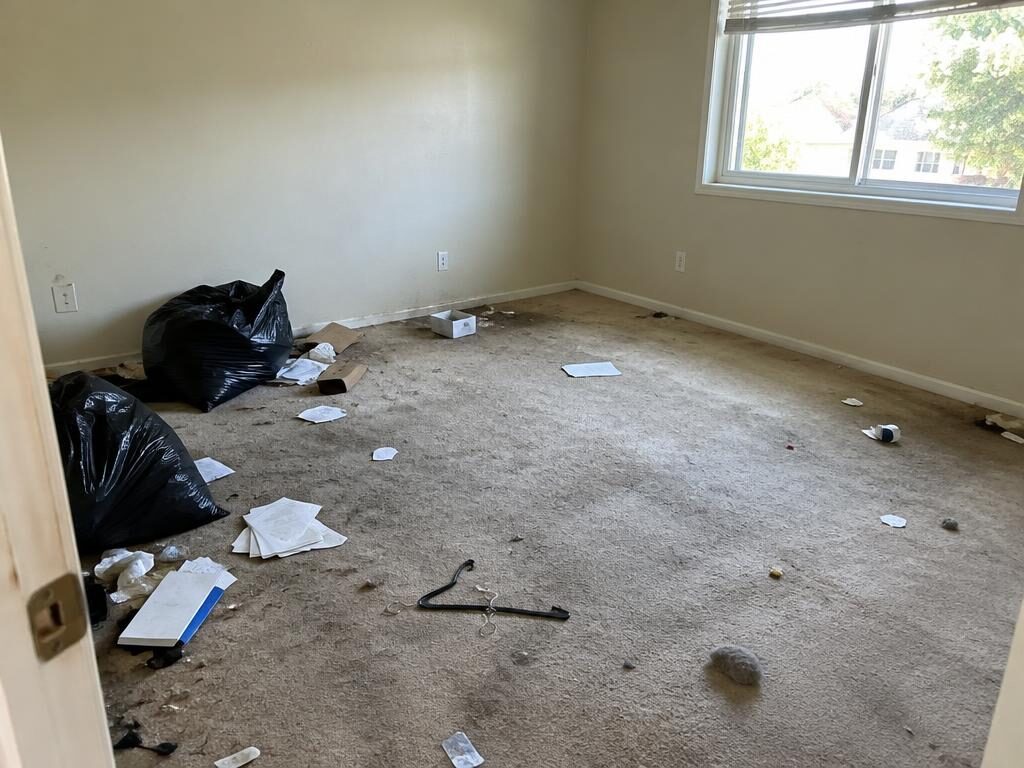 Cluttered empty room after a move-out
