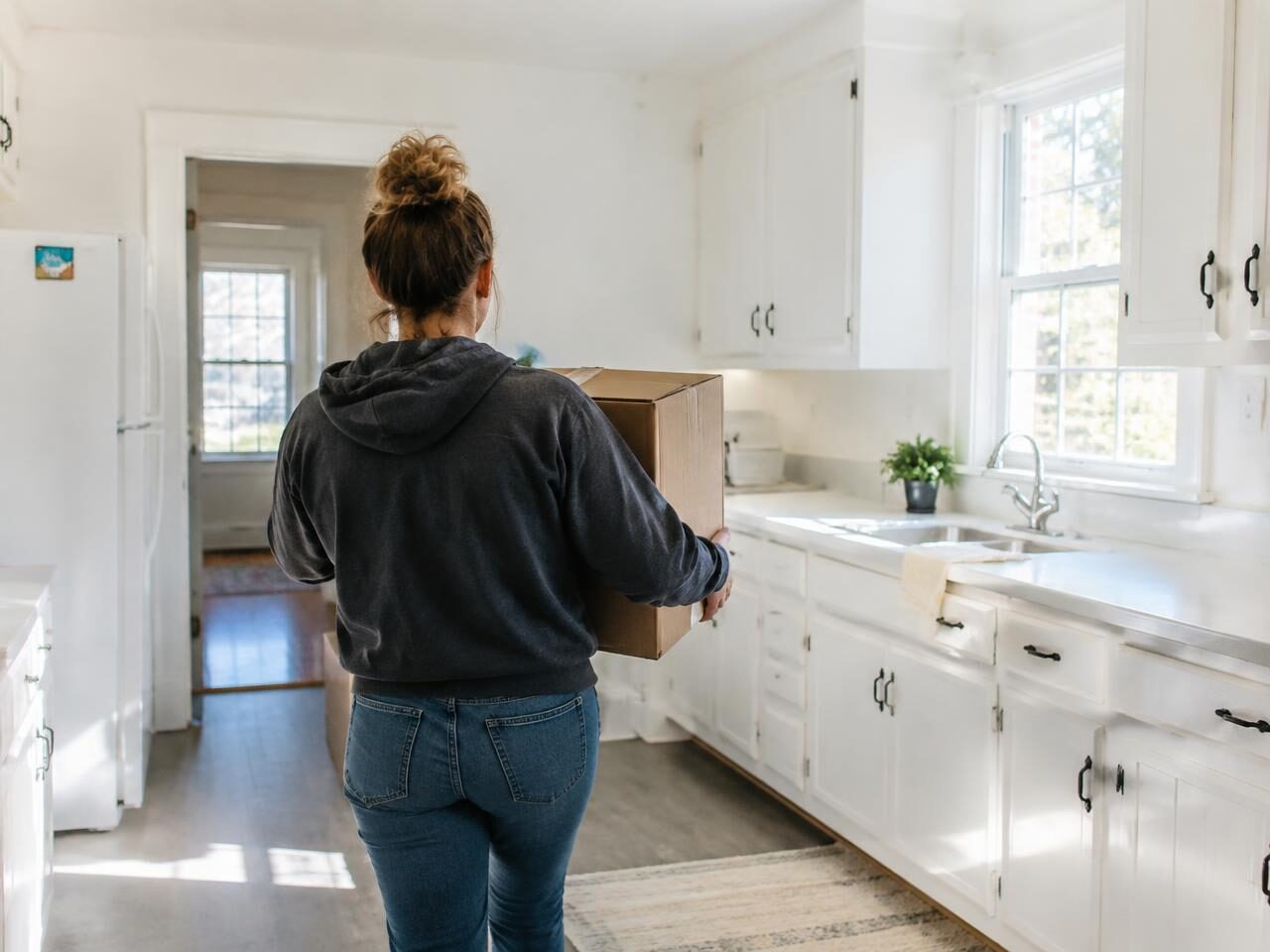 Carrying the first box into a spotless kitchen